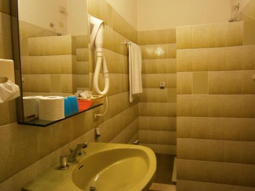 a small bathroom with a sink and a shower at Hotel Chiara in Sirmione