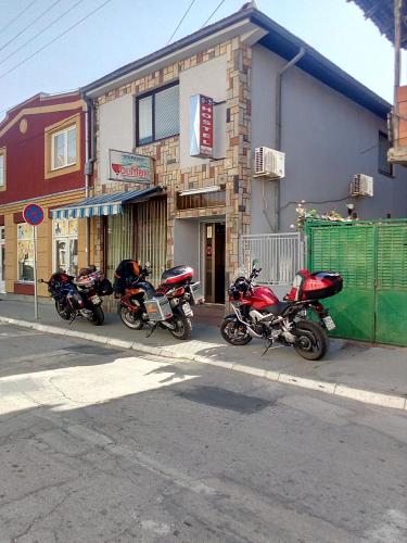 a row of motorcycles parked in front of a building at Hostel Olimpik in Negotin