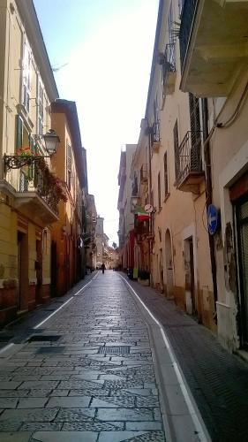 an empty street in an alley with buildings at Hotel Du Parc in Atri