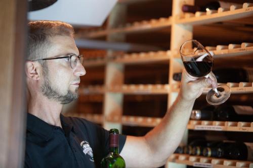 a man holding up a glass of wine at Mercure Luxembourg Kikuoka Golf & Spa in Canach