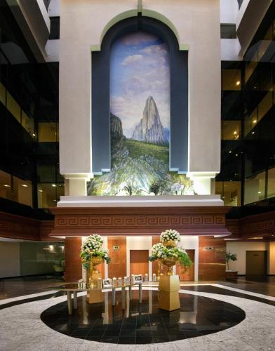 a large lobby with a large painting on the wall at Krystal Monterrey in Monterrey