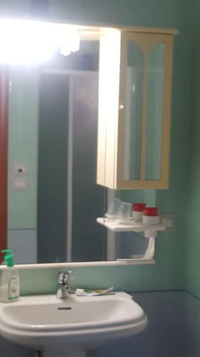 a bathroom with a sink and a mirror at appartamento Lory in Campomarino