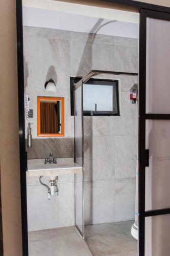 a bathroom with a sink and a mirror at Terracota Corner Rooms in Campeche