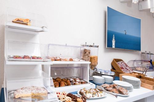 a bakery with many different types of donuts and pastries at Hermes Hotel in San Vito lo Capo