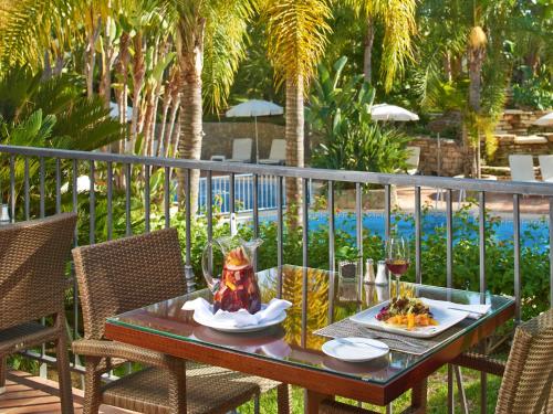 a table with two plates of food on a balcony at Vale Do Garrao Villas in Vale do Lobo