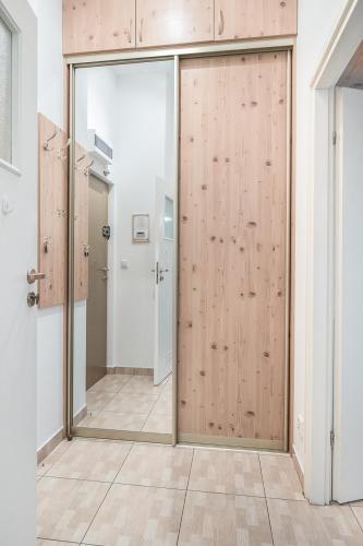 a sliding door in a room with a hallway at Apartamenty Trzy Wieze in Warsaw