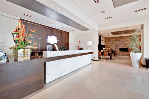 a lobby of a hotel with a reception desk at Italiana Hotels Cosenza in Cosenza