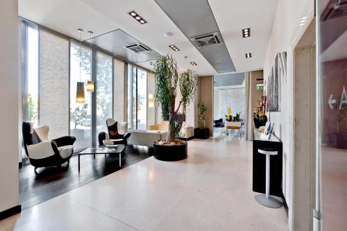 a lobby with couches and chairs at Italiana Hotels Cosenza in Cosenza