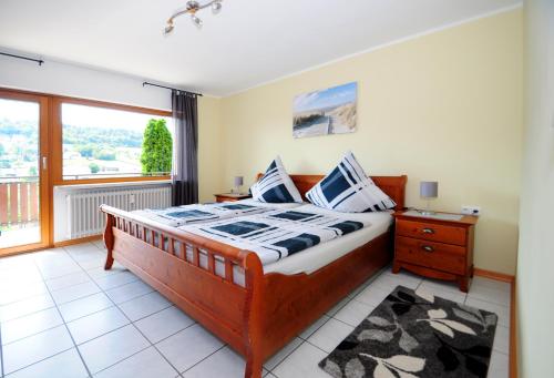 a bedroom with a bed and a large window at Ferienwohnung im Kirchberg in Lieser
