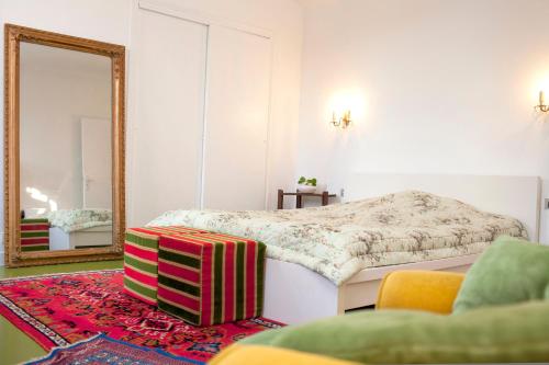 a bedroom with a bed and a mirror at 46FM : Montauban Guest House in Montauban