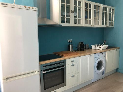 a kitchen with white cabinets and a washer and dryer at Urban apartment, in the nightlife area! in Luxembourg