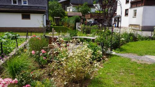 a garden with many flowers in a yard at Haus Edeltraud in Mellau