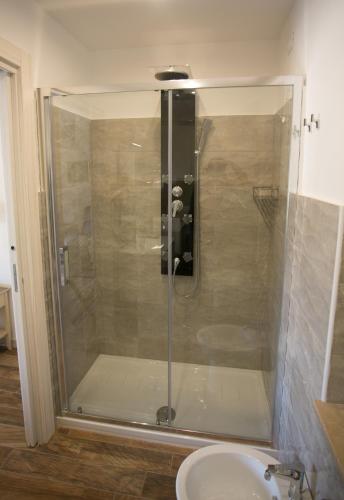 a glass shower in a bathroom with a sink at Il Duca in Tropea
