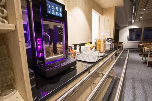 a bar in a room with a table with drinks at Sport- und Ferienhaus Don Bosco in Lenzerheide