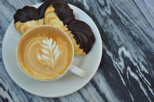 a cup of coffee and two donuts on a plate at Bluff View Inn in Chattanooga