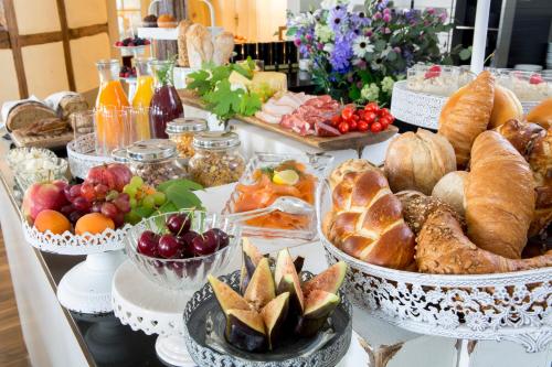 a buffet filled with different types of bread and pastries at Hotel Hirschen am See in Meilen