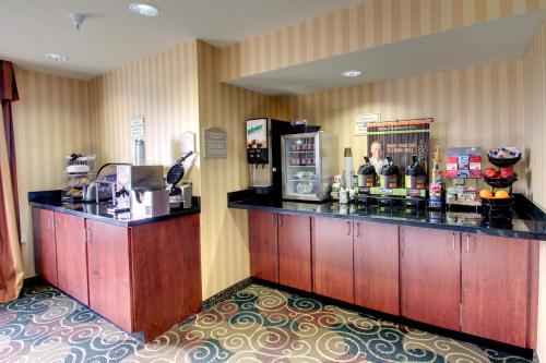 a bar in a hotel room with a counter at Cobblestone Hotel - Wayne in Wayne
