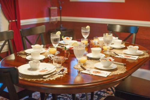 a wooden table with plates and glasses on it at Black Lantern Inn in Roanoke