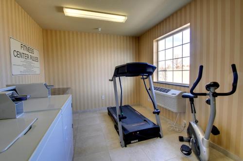 a gym with an exercise bike in a room at Cobblestone Hotel - Wayne in Wayne