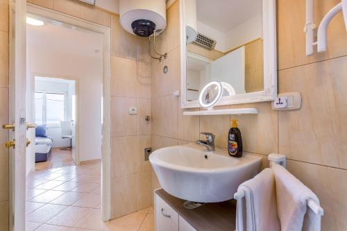 a bathroom with a sink and a mirror at Jasmina apartment in Rijeka