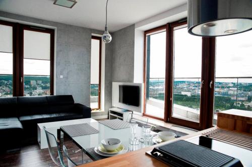a living room with a couch and a table at Sea Towers Gdynia in Gdynia