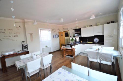 a kitchen and dining room with a table and chairs at B&B La Vecchia Tipografia - Lago D'Idro in Ponte Caffaro
