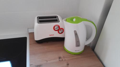 a toaster and a toaster sitting on a wooden floor at Central, spacious, great view in Hvar