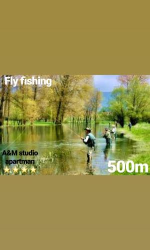 a group of people are fishing in a stream at A&M studio apartman in Otočac