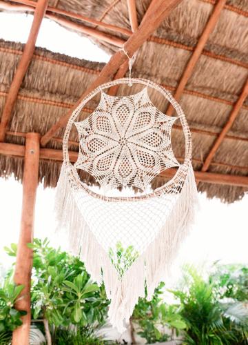 a white crochet chandalier hanging from a roof at Hotel 52 Playa del Carmen in Playa del Carmen
