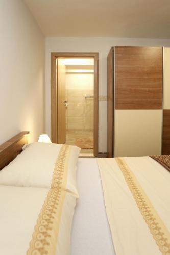 a bedroom with two beds and a door to a closet at Nona Zena in Korčula