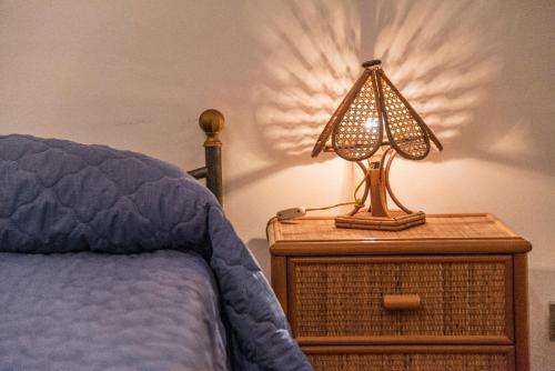 a lamp on a night stand next to a bed at B&B Le Balate in Augusta