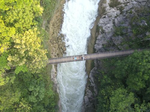 an aerial view of a suspension bridge over a waterfall at Ecolodge Las Nubes Chiapas in La Fortuna Gallo Giro