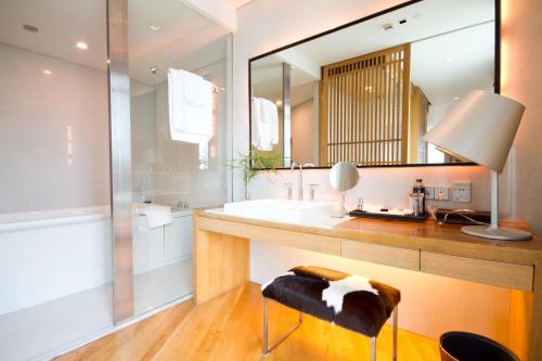 a bathroom with a sink and a mirror at Maduzi Hotel, Bangkok - Asoke in Bangkok