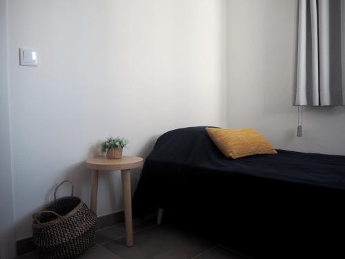 a bedroom with a bed and a small table at Casa AUGUSTA in Lagos