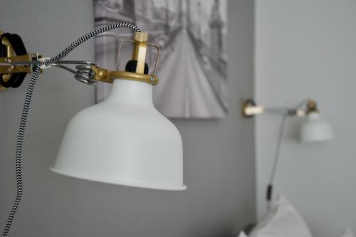 een witte lamp in een badkamer naast een spiegel bij Standard Apartment by Hi5 - Asbóth 15 in Boedapest