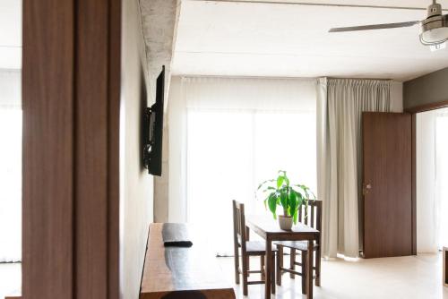 a dining room with a table and chairs and a window at Hotel 52 Playa del Carmen in Playa del Carmen
