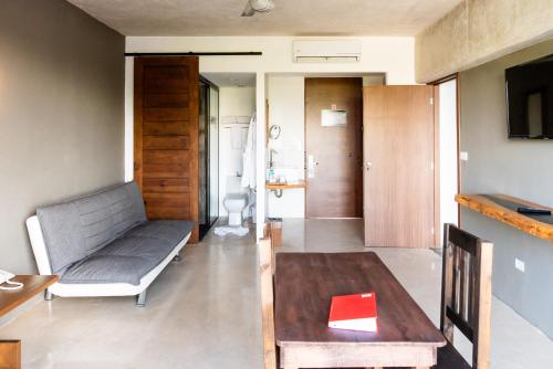 a living room with a couch and a table at Hotel 52 Playa del Carmen in Playa del Carmen