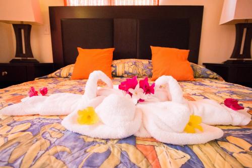 two swans made out of towels on a bed at Connie's Comfort Suites in Saint Johnʼs