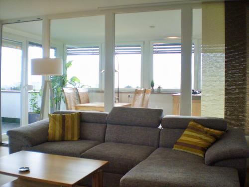 a living room with a couch and a table at PenthouseApartment 250° in Sonthofen
