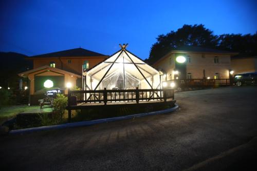 a large tent in front of a house at night at Daegwanryeong Rodem Tree Pension in Pyeongchang 