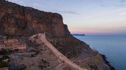 an aerial view of a cliff next to the ocean at Bastione Malvasia Hotel (ex New Malvasia) in Monemvasia