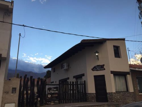 a building with a fence in front of it at Casa El Mortero in Cafayate