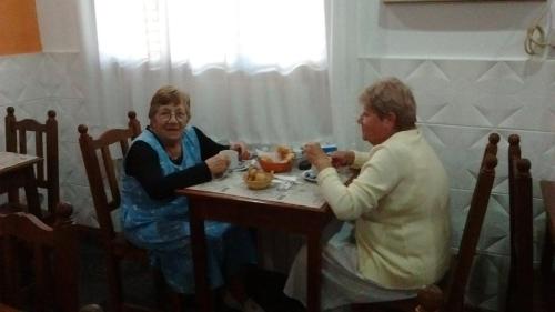 two older women sitting at a table drinking tea at Dennisse Hotel in Victoria