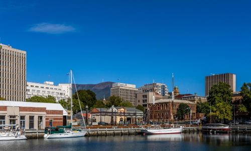 a city with boats docked in a harbor with buildings at Salamanca Suites in Hobart