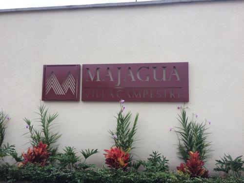 a sign on the side of a building with plants at Calima Darien in Calima