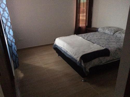 a bedroom with a bed and a wooden floor at Calima Darien in Calima