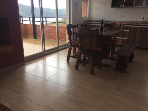 a dining room with a wooden table and chairs at Calima Darien in Calima