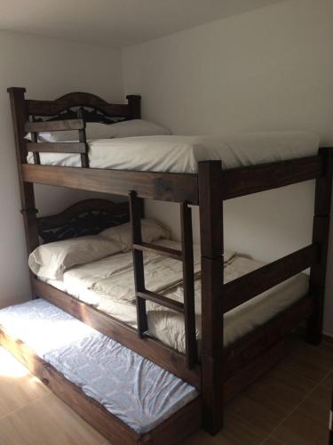 two wooden bunk beds in a room with a wall at Calima Darien in Calima