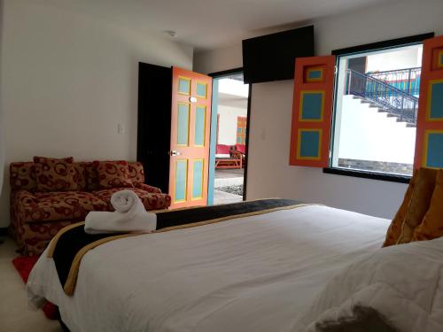 a bedroom with a bed and a room with a door at Beta Hotel in Salento