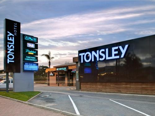 a sign for a tottenney store on the side of a road at Tonsley Hotel in Adelaide